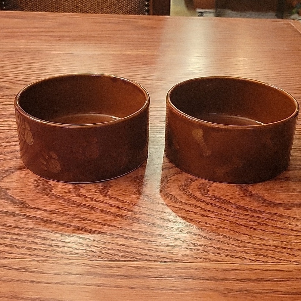 Two dark brown ceramic stoneware dog bowls.  5" in diameter 2 1/4' high